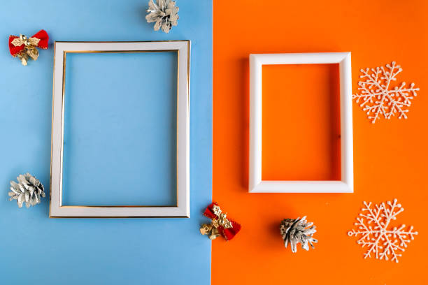 istock Two photo frames and Christmas decorations on color background, copy space for the text. Template for Christmas greeting card. Merry Christmas and Happy New Year 1278851141