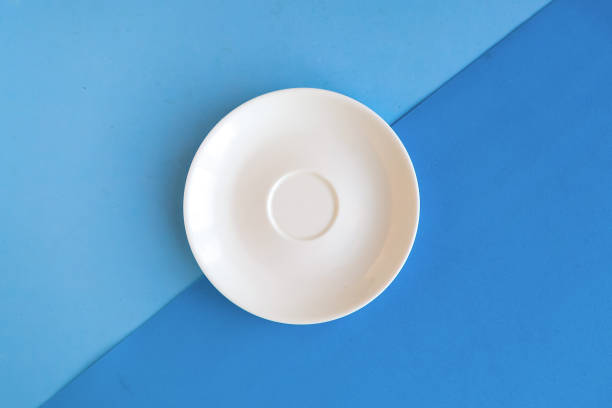 istock Empty plate on blue geometric background. Copy space for the text. Minimal concept 1278851181
