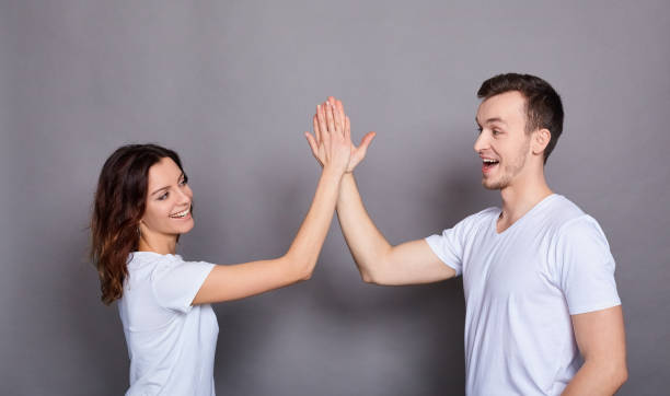 istock A beautiful young couple gives five to each other. 1278852274