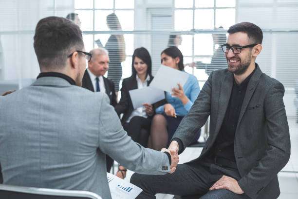 istock close up. business people shaking hands in agreement 1278853240