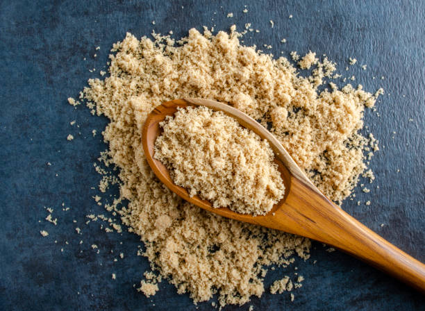 istock Light Brown Sugar On Wooden Spoon 1278853429