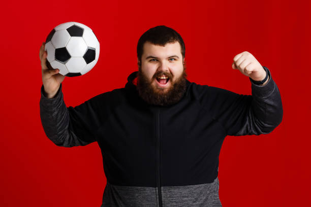 istock Happy young man holding a soccer ball 1278855382