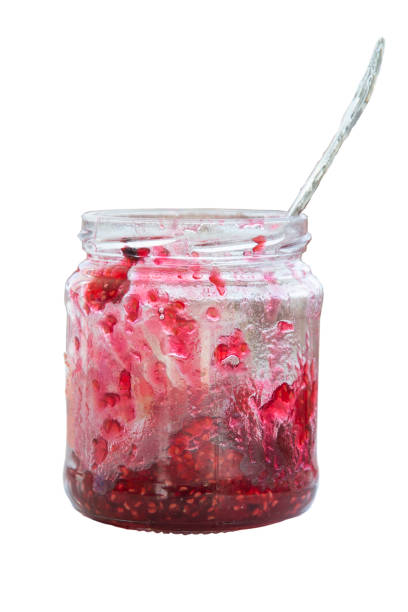 istock madine jam in a jar with a spoon, jar half empty, tea with raspberry jam, flu prevention. 1278856269