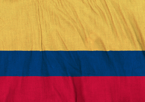 Flag of Colombia on a crumpled canvas background