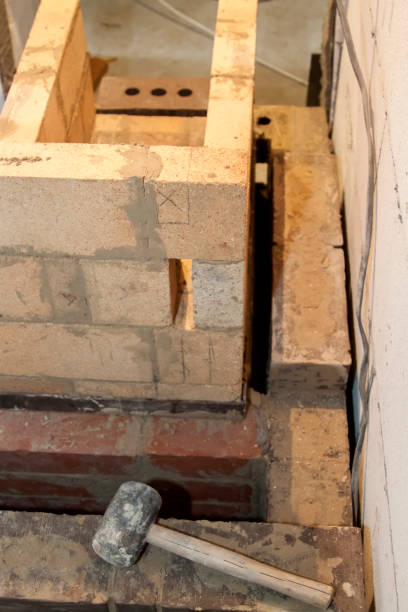istock Sauna stove that is being built from fire resistant material in undeveloped interior laid out of foam blocks in country house under construction 1278857742