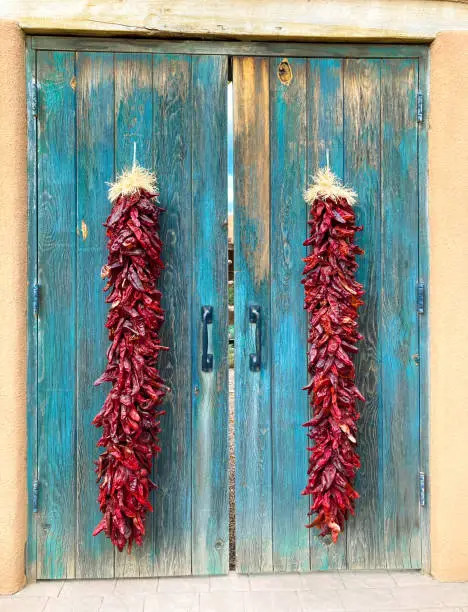 New Mexico: Long Chili Pepper Ristras on Old Turquoise Doors.