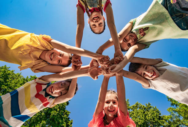 istock Group of kids gathering their hands in unity 1278858400