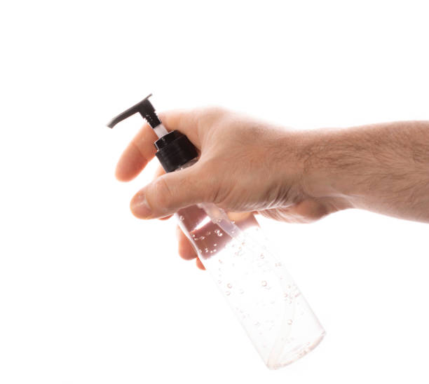 istock man's hand holds antiseptic gel from a transparent plastic bottle on a white background. concept of counteracting the virus, clean hands. 1278861554