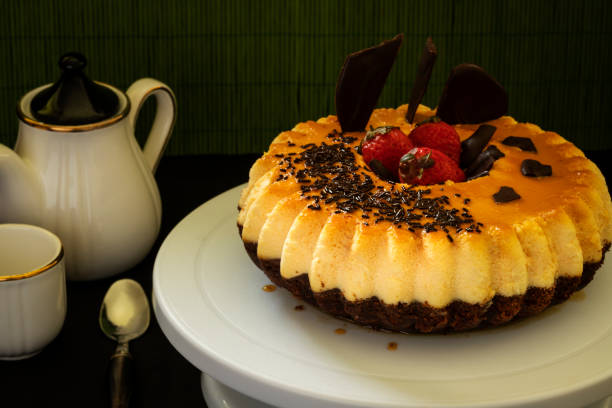 chocolate cake and flan (chocoflan) on a white cake plate and a dark background. horizontal shot and selective focus - dessert ready to eat creme brulee food imagens e fotografias de stock