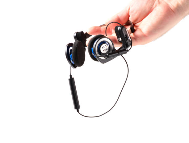 istock man's hand holds classic black headphones with bluetooth headset. isolated background. music listening concept. 1278865770