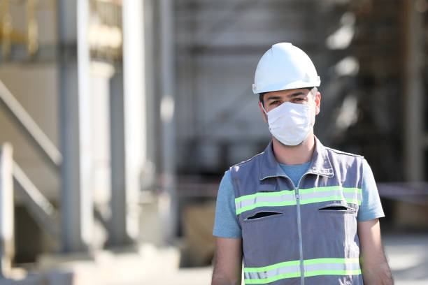 istock The worker (staff, engineer) protects himself from covid-19 (coronavirus) with a protective mask in the construction site. 1278866822