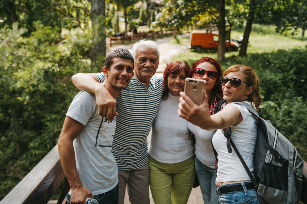 istock Happy family taking selfie on footbridge 1278868511