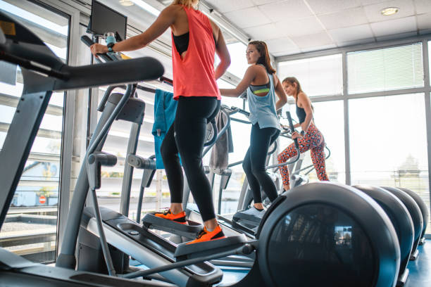 istock Fit Young Women Using Cross Trainers at Gym 1278875387