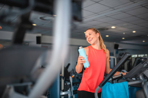istock Relaxed Young Woman Working Out on Elliptical Trainer 1278875390