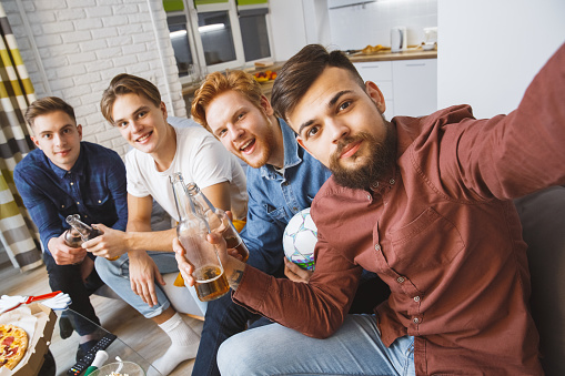 Guys watching sport on tv together stag-party taking selfie photos smiling happy close-up