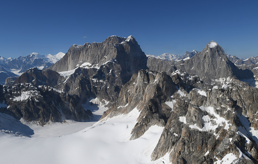 Iconic complex of very difficult to climb rock peaks called Mooses Tooth (10,335 feet/ 3139 m) or Moose’s Tooth and Broken Tooth (on the right) located near the Ruth Gorge in Central Alaska Range, within Denali National Park. East-to-west summit ridge is nearly mile-long.