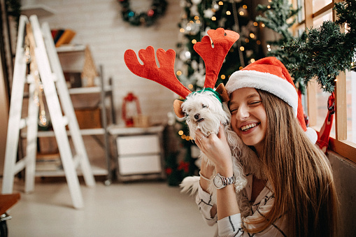 Teenage girl waiting for Christmas with her dog