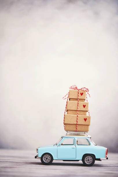 istock Little blue car with gift stack on roof rack 1278883257