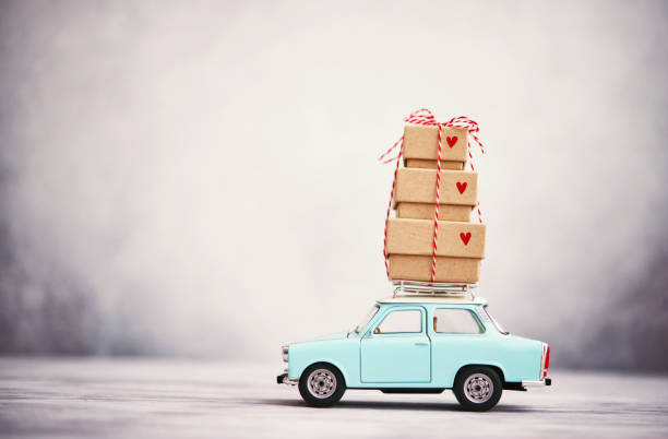 istock Little blue car with gift stack on roof rack 1278883261