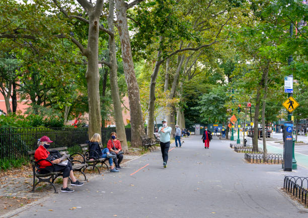 Upper West Side NYC During Pandemic New York, New York, USA - October 5, 2020: People walking and seated on Columbus Avenue on the Upper West Side of Manhattan during the Corona-virus Pandemic. columbus avenue stock pictures, royalty-free photos & images