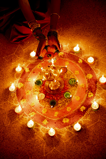 Beautiful young Indian girl holding Diwali oil lamp