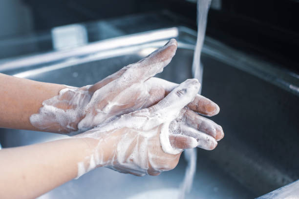 istock Woman hand washing with soap 1278889138
