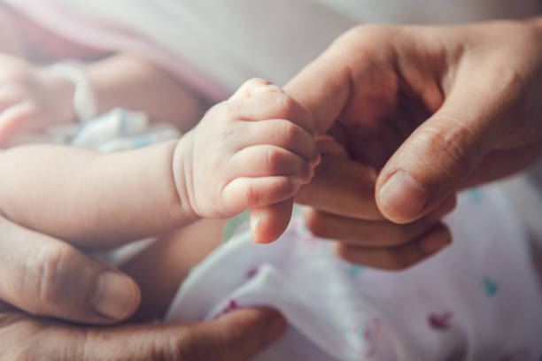 istock Newborn baby holding mother's hand. 1278889521