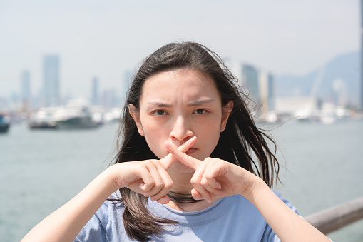 Women making stop gesture with two crossed palms