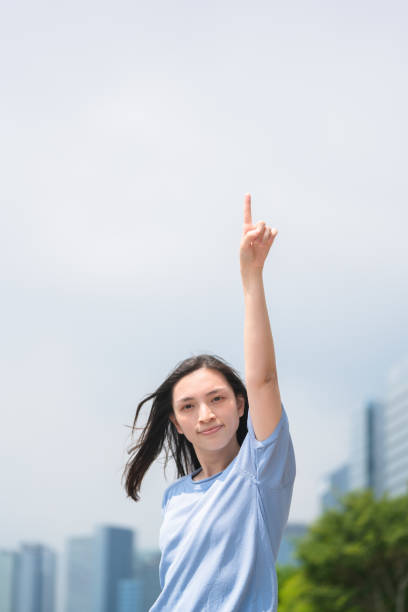 Asian woman pointing her finger to confirm
