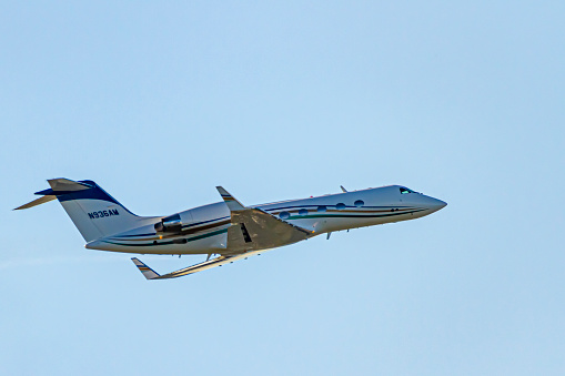 Washington DC, USA 10/03/2020: A fixed wing, multi engine private jet  (Cessna 525C CitationJet CJ4 ) is departing from Ronald Reagan National Airport. Isolated close up image of the airplane in air.