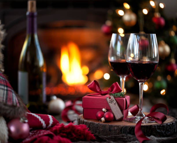 istock Christmas red wine and a gift in front of a fireplace. 1278895776
