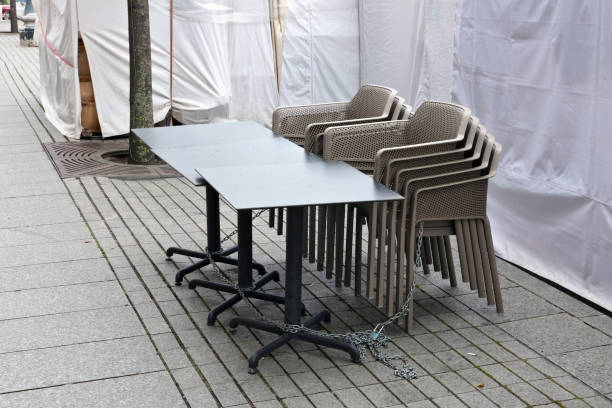 Stack of metal brown chairs and tables in closed coffee shop