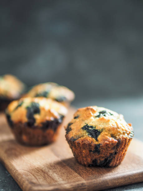 istock Homemade blueberry muffins on dark background. 1278904415