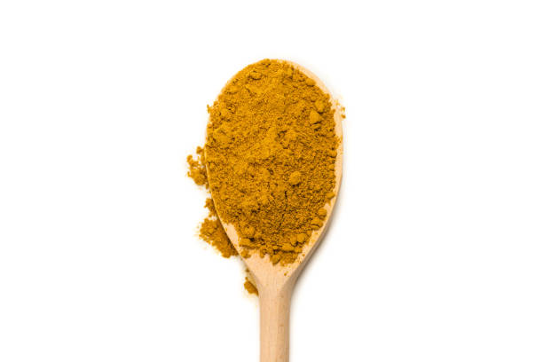 istock Curry in wooden spoon isolated on white. 1278905314