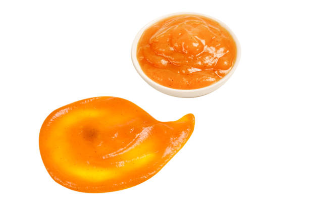 istock Orange sauce splashes isolated on white background 1278905361