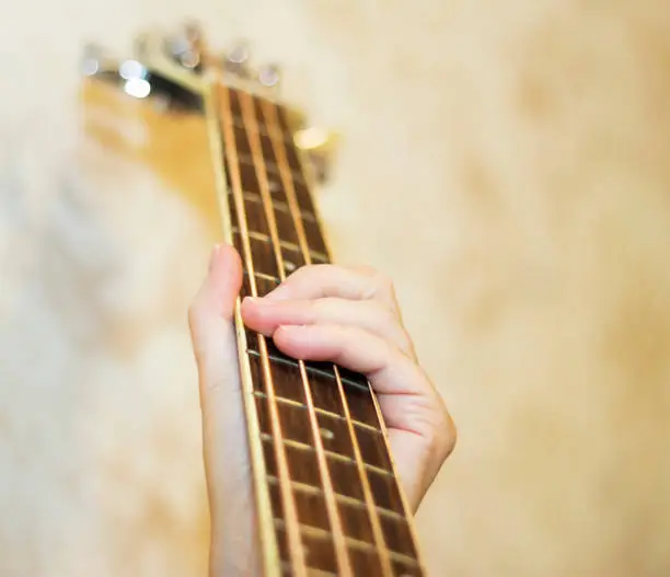 Female holding An acoustic bass guitar and play music