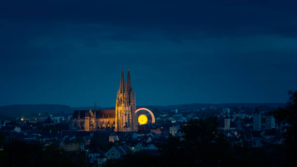 Photo of Skyline of UNESCO world heritage site town Regensburg with Octoberfest ferris wheel at night