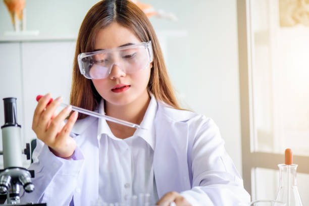 istock Attractive young Asian scientist woman lab technician assistant analyzing sample in test tube at laboratory. Medical, pharmaceutical and scientific research and development concept. 1278910443