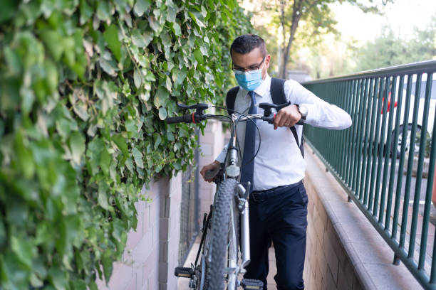 istock Businessman is carrying bicycle up steps to go to work 1278911710