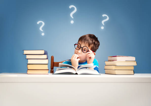 istock Seven years old child reading a book 1278913554