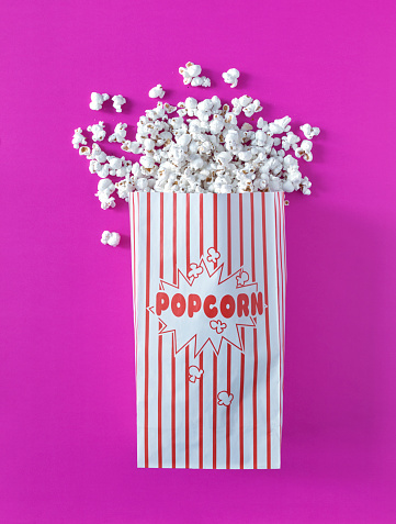 Popcorn bag on colored background