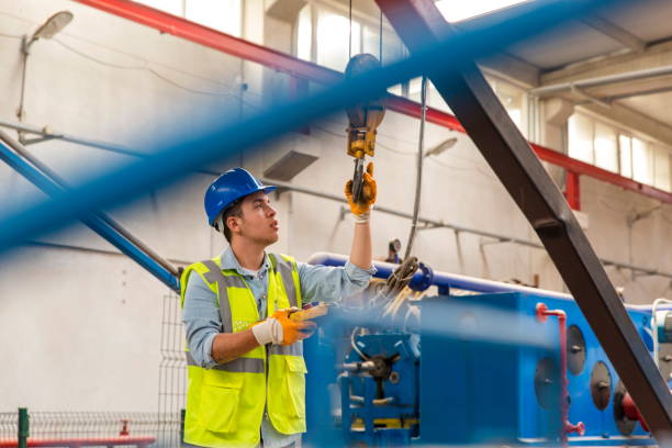 istock Young businessman holding and working with remote control for operating crane 1278915707