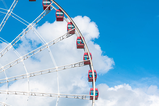 White ferris wheel on a blue pastel sky background