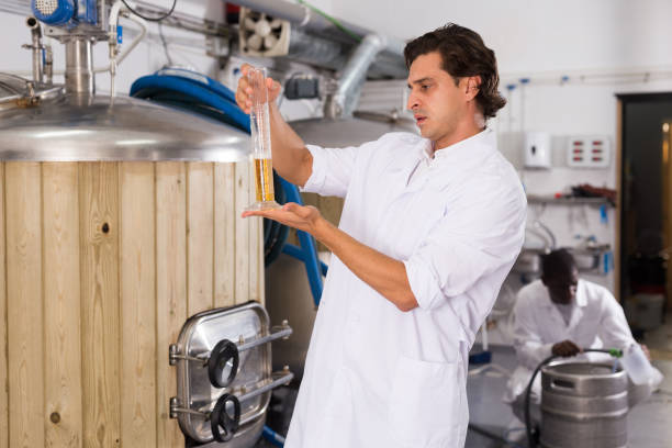 istock Young man expert is standing with flask for beer and analizying 1278916913