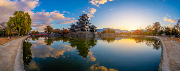 Panorama view of Matsumoto Castle with its reflection in autumn, Matsumoto, Nagano Prefecture, Japan on sunrise. panoramic. 11/16/2019 - Matsumoto, Nagano, Japan.