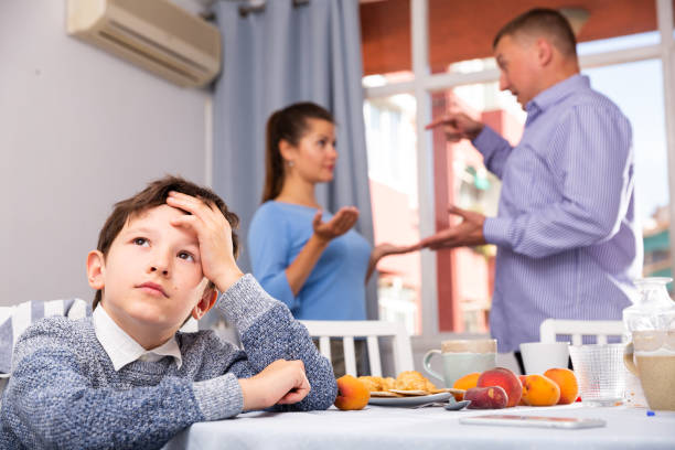 istock Unhappy boy with quarreling parents 1278917964