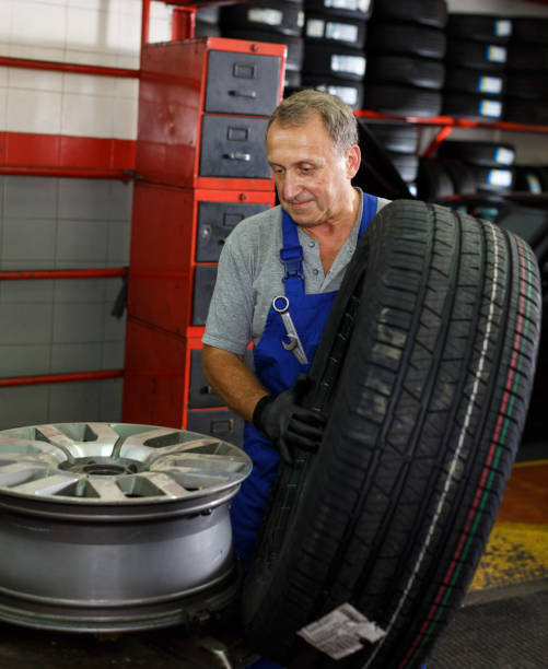 istock Mechanician removing tire from wheel disc 1278919433
