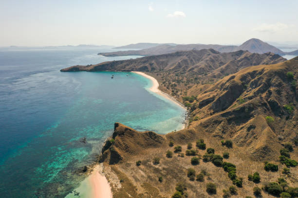 istock Aerial view Pale pink sandy beach with clear waters & reef teeming with tropical fish & some strong currents, called Pink Beach or Long Island located in Komodo National Park, East Nusa Tenggara, Indonesia. 1278920926