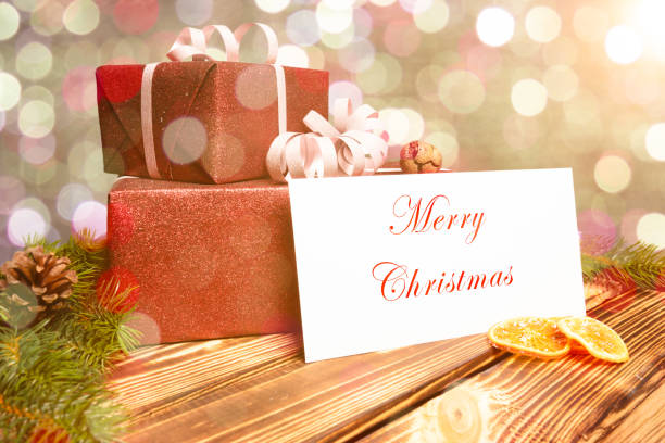 istock Christmas presents on a wooden table with a greeting card 1278923004