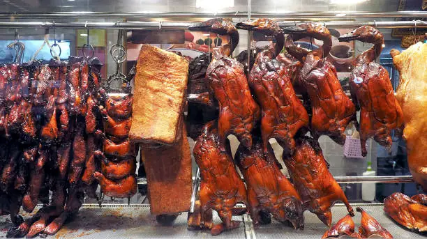 traditional chinese cuisine - roasted duck and pork hanging common display at the asia local restaurant